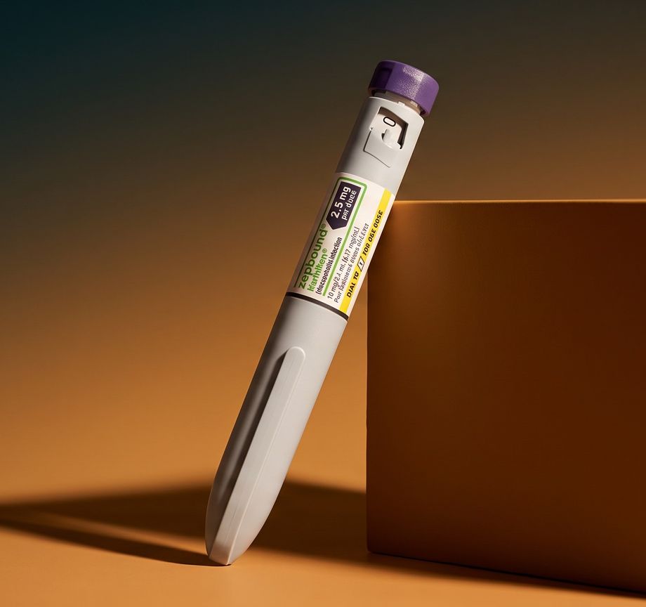 A Zepbound pen leaning on a box in warm light